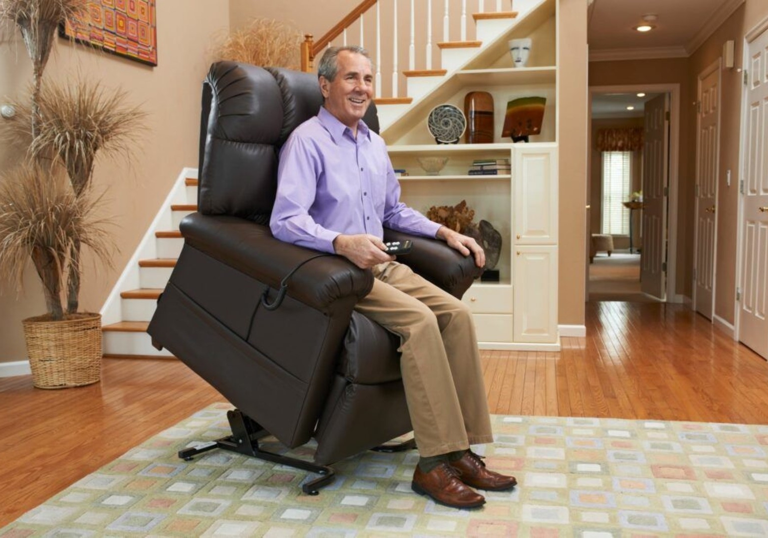 Senior man using lift chair.